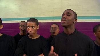 Movie still from “Fahrenheit 9/11” (2004), directed by Michael Moore – A group of young men standing next to each other; Close Up shot, Low angle