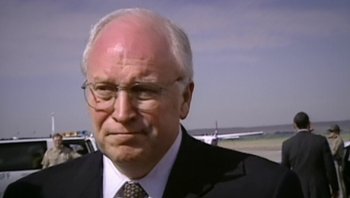 Movie still from “Fahrenheit 9/11” (2004), directed by Michael Moore – An older man wearing a suit and tie; Close Up shot, High angle
