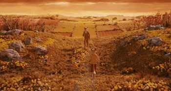 Movie still from “Fantastic Mr. Fox” (2009), directed by Wes Anderson – Two people walking on a dirt path in a field; Wide shot, High angle