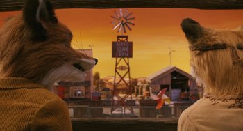 Movie still from “Fantastic Mr. Fox” (2009), directed by Wes Anderson – A man and a woman looking out a window at an amusement park; Close Up shot, Over the shoulder angle
