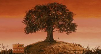 Movie still from “Fantastic Mr. Fox” (2009), directed by Wes Anderson – A tree on top of a hill with a person standing on top of it; Extreme Wide shot, Low angle