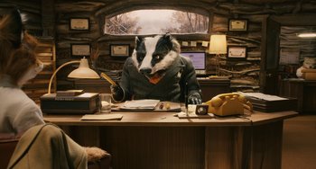 Movie still from “Fantastic Mr. Fox” (2009), directed by Wes Anderson – A badger sitting at a desk in front of a computer; Medium shot, High angle