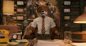 Movie still from “Fantastic Mr. Fox” (2009), directed by Wes Anderson – A man sitting at a desk wearing a suit and tie; Medium shot, High angle