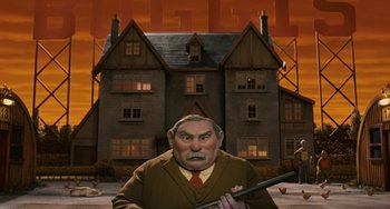 Movie still from “Fantastic Mr. Fox” (2009), directed by Wes Anderson – An old man holding a gun in front of a house; Wide shot, Low angle