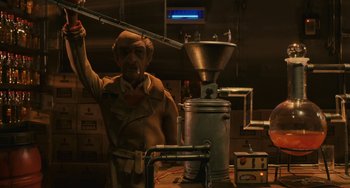 Movie still from “Fantastic Mr. Fox” (2009), directed by Wes Anderson – A man standing next to a machine in a room; Medium shot, Low angle