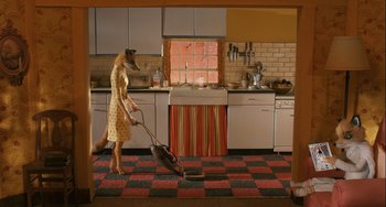 Movie still from “Fantastic Mr. Fox” (2009), directed by Wes Anderson – A woman is vacuuming the floor in the kitchen; Wide shot, High angle