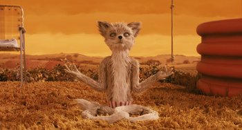 Movie still from “Fantastic Mr. Fox” (2009), directed by Wes Anderson – An animal that is sitting in the grass; Medium shot, High angle