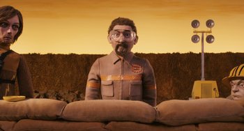 Movie still from “Fantastic Mr. Fox” (2009), directed by Wes Anderson – An animated figure of a man in a field; Medium shot, Low angle