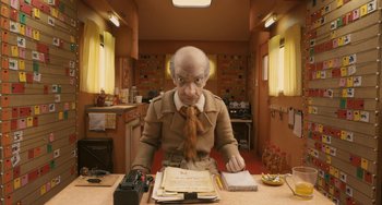 Movie still from “Fantastic Mr. Fox” (2009), directed by Wes Anderson – An old man sitting at a table in a kitchen; Medium shot, Low angle