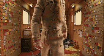 Movie still from “Fantastic Mr. Fox” (2009), directed by Wes Anderson – A man wearing a fur coat standing in front of a window; Medium shot, Low angle