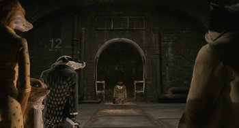 Movie still from “Fantastic Mr. Fox” (2009), directed by Wes Anderson – A man sitting in front of an open door; Wide shot, High angle