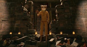 Movie still from “Fantastic Mr. Fox” (2009), directed by Wes Anderson – A man with a cat mask standing on a pile of rocks; Wide shot, High angle