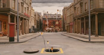 Movie still from “Fantastic Mr. Fox” (2009), directed by Wes Anderson – An empty street with a fire hydrant in the middle of the street; Extreme Wide shot, High angle