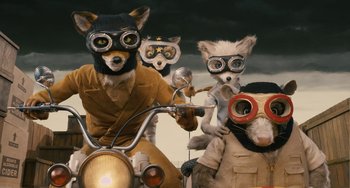 Movie still from “Fantastic Mr. Fox” (2009), directed by Wes Anderson – A group of dogs dressed up like a person on a motorcycle; Medium shot, High angle