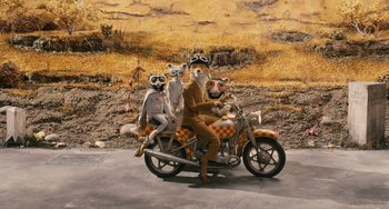 Movie still from “Fantastic Mr. Fox” (2009), directed by Wes Anderson – A man and two dogs on a motorcycle; Wide shot, High angle