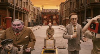 Movie still from “Fantastic Mr. Fox” (2009), directed by Wes Anderson – A group of men in suits sitting on top of a bench; Wide shot, High angle
