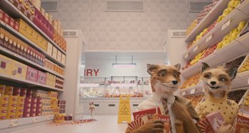 Movie still from “Fantastic Mr. Fox” (2009), directed by Wes Anderson – A stuffed animal dog sitting in a store with other stuffed animals; Wide shot, High angle