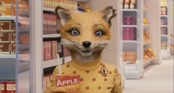 Movie still from “Fantastic Mr. Fox” (2009), directed by Wes Anderson – A person in a yellow shirt holding an apple juice box; Close Up shot, Over the shoulder angle