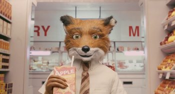 Movie still from “Fantastic Mr. Fox” (2009), directed by Wes Anderson – A man in a fox mask holding an apple drink; Close Up shot, High angle