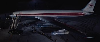 Movie still from “Fantastic Voyage” (1966), directed by Richard Fleischer – A group of people standing next to an airplane; Extreme Wide shot, High angle