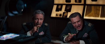 A couple of men sitting next to each other at a table