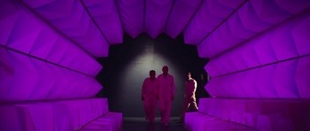 Movie still from “Fantastic Voyage” (1966), directed by Richard Fleischer – Three men are walking through a tunnel of purple lights; Wide shot, Low angle