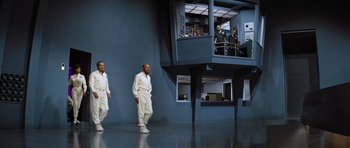 Movie still from “Fantastic Voyage” (1966), directed by Richard Fleischer – Two men are walking in front of an elevator; Extreme Wide shot, Low angle