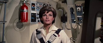 Movie still from “Fantastic Voyage” (1966), directed by Richard Fleischer – A person wearing a suit and tie; Medium shot, Low angle