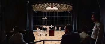 Movie still from “Fantastic Voyage” (1966), directed by Richard Fleischer – A group of men in white lab coats in a room; Wide shot, Over the shoulder angle