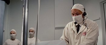 Movie still from “Fantastic Voyage” (1966), directed by Richard Fleischer – A man in a white robe and a woman in a white robe; Medium shot, Over the shoulder angle