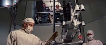 Movie still from “Fantastic Voyage” (1966), directed by Richard Fleischer – A group of people standing in front of a window; Medium shot, Low angle
