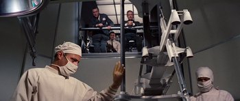 Movie still from “Fantastic Voyage” (1966), directed by Richard Fleischer – A group of people standing in front of a window; Medium shot, Low angle