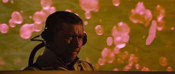 Movie still from “Fantastic Voyage” (1966), directed by Richard Fleischer – A man with headphones is sitting in front of a projection screen; Close Up shot, Low angle