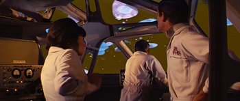 Movie still from “Fantastic Voyage” (1966), directed by Richard Fleischer – A group of people standing in front of a projection screen; Medium shot, Low angle