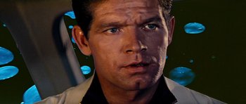 Movie still from “Fantastic Voyage” (1966), directed by Richard Fleischer – A man's face in front of a blue background; Close Up shot, Over the shoulder angle
