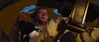 Movie still from “Fantastic Voyage” (1966), directed by Richard Fleischer – A man wearing headphones and a white dress shirt; Medium shot, Low angle