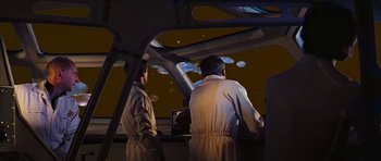 Movie still from “Fantastic Voyage” (1966), directed by Richard Fleischer – Two men are standing in front of a screen; Medium shot, Low angle