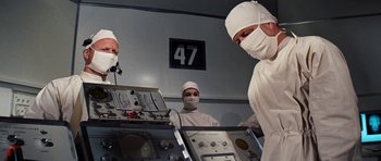 Movie still from “Fantastic Voyage” (1966), directed by Richard Fleischer – A group of doctors in a operating room; Medium shot, Low angle