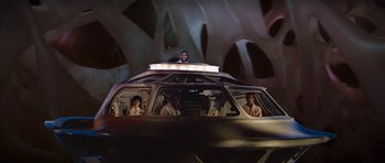 Movie still from “Fantastic Voyage” (1966), directed by Richard Fleischer – A group of people standing in the back of a vehicle; Wide shot, Low angle