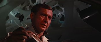 Movie still from “Fantastic Voyage” (1966), directed by Richard Fleischer – A person wearing a suit and tie; Close Up shot, Low angle