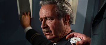 Movie still from “Fantastic Voyage” (1966), directed by Richard Fleischer – An older man is holding a stopwatch in front of his face; Close Up shot, Low angle