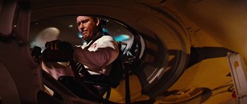 Movie still from “Fantastic Voyage” (1966), directed by Richard Fleischer – A man riding on the back of an airplane; Medium shot, Low angle