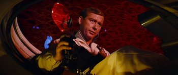 Movie still from “Fantastic Voyage” (1966), directed by Richard Fleischer – A man holding a microphone in his hands; Close Up shot, Low angle