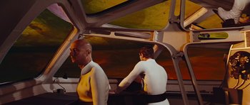 Movie still from “Fantastic Voyage” (1966), directed by Richard Fleischer – A man and a woman are standing on a treadmill; Medium shot, Low angle