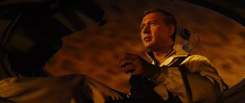 Movie still from “Fantastic Voyage” (1966), directed by Richard Fleischer – A man sitting in front of a microphone in a dark room; Close Up shot, Low angle