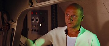 Movie still from “Fantastic Voyage” (1966), directed by Richard Fleischer – A man with a bald head is standing in front of a control panel; Close Up shot, Low angle
