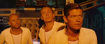Movie still from “Fantastic Voyage” (1966), directed by Richard Fleischer – Two men are standing in front of each other; Medium shot, Low angle