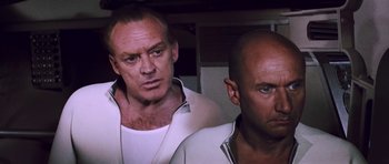 Movie still from “Fantastic Voyage” (1966), directed by Richard Fleischer – Two men are standing next to each other in a room; Close Up shot, Low angle