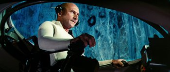 Movie still from “Fantastic Voyage” (1966), directed by Richard Fleischer – A man with headphones on sitting in an airplane cockpit; Medium shot, Low angle