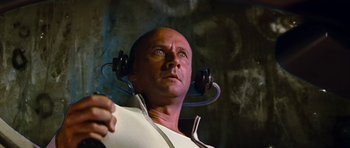 Movie still from “Fantastic Voyage” (1966), directed by Richard Fleischer – A bald man with headphones on his head; Close Up shot, Low angle